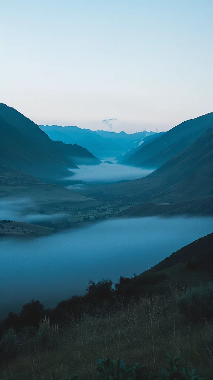 An empty, foggy valley at dawn, no footprints, no 