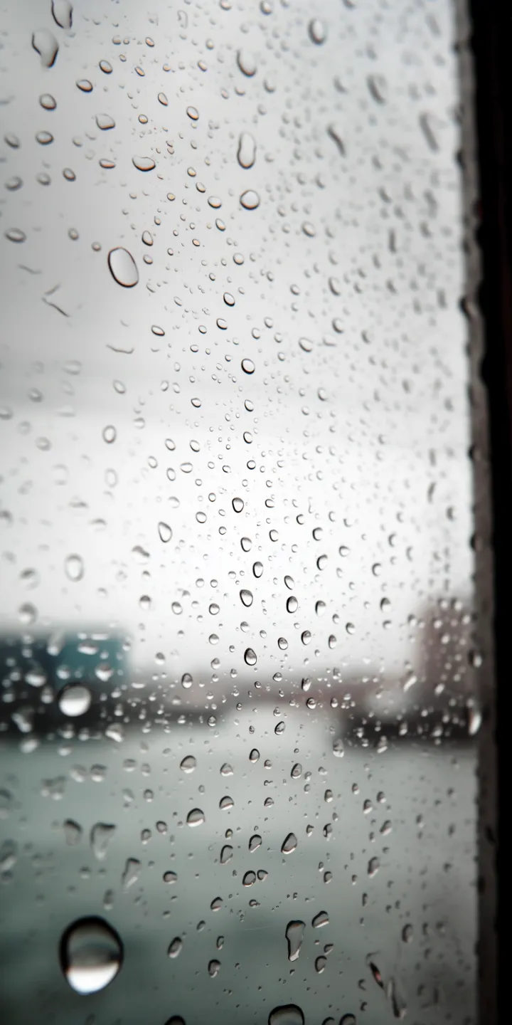 straight on view of water droplets on a window wit